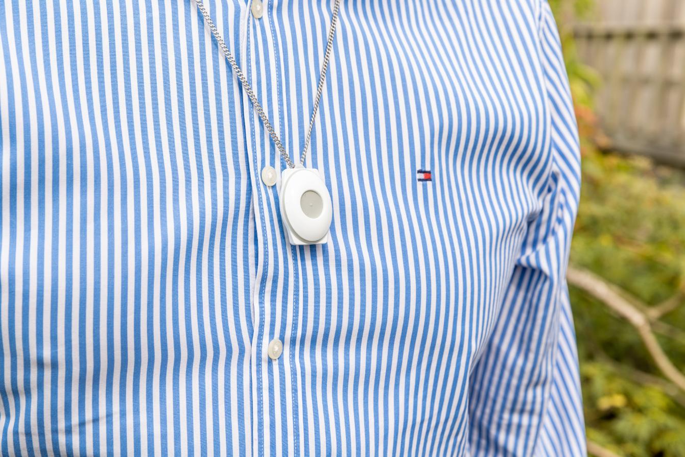 A close-up of the Red Button pendant being worn
